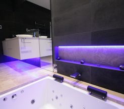 Sydney Bathroom Renovators - Black tile bathroom with light under sink cabinet