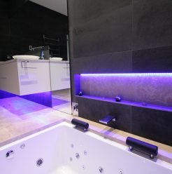 Sydney Bathroom Renovators - Black tile bathroom with light under sink cabinet