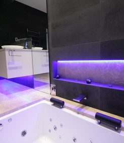 Sydney Bathroom Renovators - Black tile bathroom with light under sink cabinet
