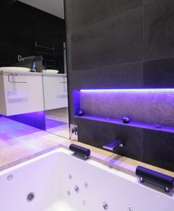 Sydney Bathroom Renovators - Black tile bathroom with light under sink cabinet