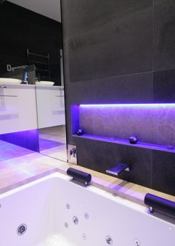 Sydney Bathroom Renovators - Black tile bathroom with light under sink cabinet