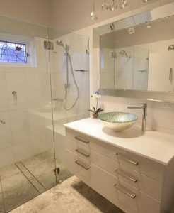 Sydney Bathroom Renovators - Small bathroom with white shower and white cabinets