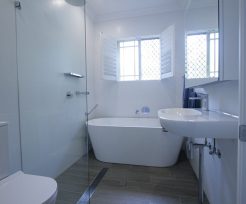 Sydney Bathroom Renovators - Small white bathroom with bathtub at the end