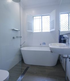 Sydney Bathroom Renovators - Small white bathroom with bathtub at the end