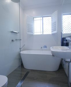 Sydney Bathroom Renovators - Small white bathroom with bathtub at the end