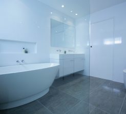 Sydney Bathroom Renovators - bathroom with grey flooring tiles and white walls - view on bathtub