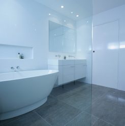 Sydney Bathroom Renovators - bathroom with grey flooring tiles and white walls - view on bathtub