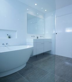 Sydney Bathroom Renovators - bathroom with grey flooring tiles and white walls - view on bathtub